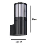 Black metal outdoor wall sconce with vertical ribbed design