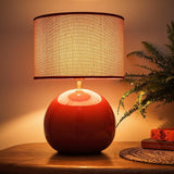 glossy red ceramic lamp with textured drum shade