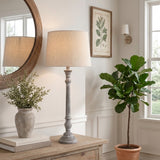 Decorative turned base of distressed grey wooden effect table lamp