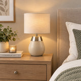 Cream table lamp with fabric drum shade and brushed metal detail