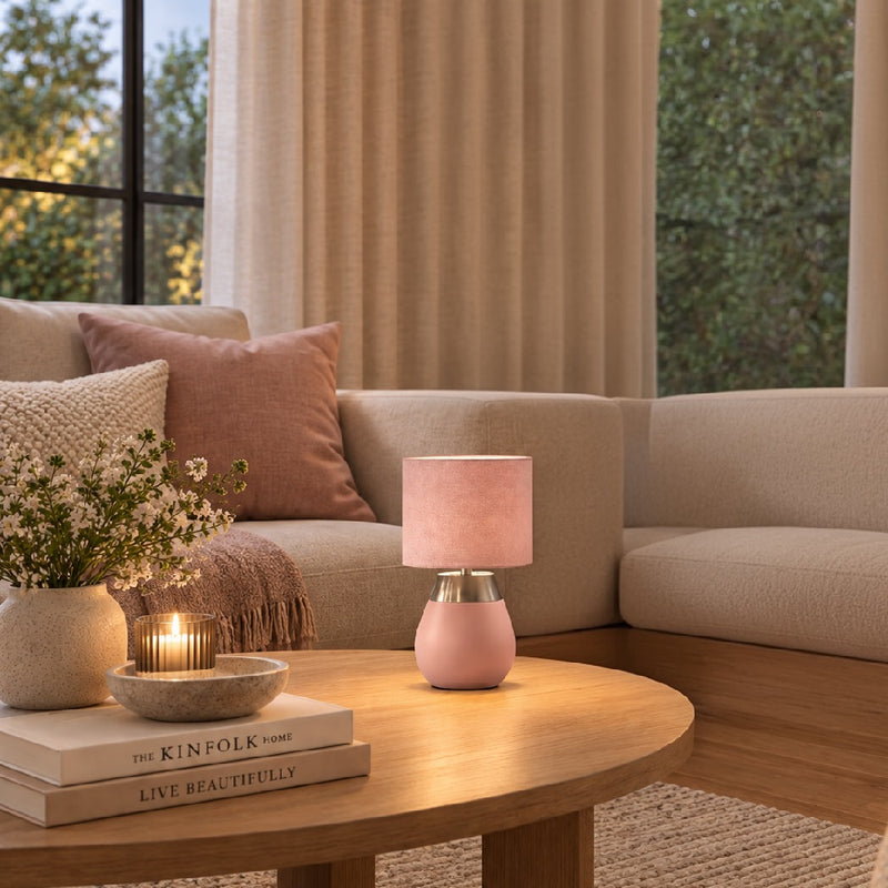 Pink table lamp with fabric drum shade and brushed metal detail