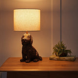 Bronze dog-shaped table lamp with a white lampshade