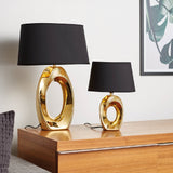 Contemporary gold sculptural base table lamp with black shade