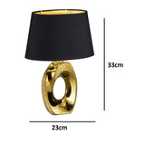 Modern bedside table lamp with gold base and black fabric shade